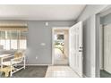 Bright foyer with tile flooring, neutral walls, and decorative storm door view at 10683 Se 174Th Loop, Summerfield, FL 34491