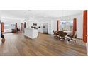 Open-concept living room features hardwood floors, and modern decor at 1674 Cadorette Dr, The Villages, FL 34762