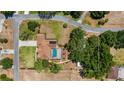 Aerial view of property featuring a private pool, mature trees, lush landscaping, and generous backyard space at 17825 Whisperwind Dr, Clermont, FL 34715