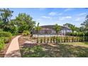 Screened-in pool and backyard featuring professional landscaping and walkway at 17825 Whisperwind Dr, Clermont, FL 34715