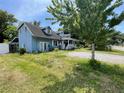 Spacious blue home with a gravel driveway and a covered porch at 1920 Baxter Ave, Orlando, FL 32806