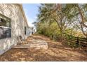 Serene backyard featuring a stone patio and a lush, tree-lined perimeter for privacy at 2036 Chesapeake Pl, The Villages, FL 32162
