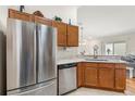 Modern kitchen featuring stainless steel appliances, granite countertops, and ample cabinet space at 2036 Chesapeake Pl, The Villages, FL 32162
