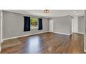 Spacious living room with hardwood flooring, neutral paint, and a large window at 2209 Hutchinson Ave, Leesburg, FL 34748
