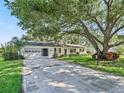 Charming single-story home with a well-maintained front yard and attached two car garage at 2401 Greenlaw Ct, Leesburg, FL 34788