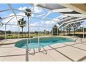 Inviting screened-in pool with golf course views at 2706 Radbourne Way, The Villages, FL 32162