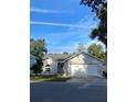 Well-kept gray brick home featuring a two-car garage and neat front lawn at 38 Townhill Dr, Eustis, FL 32726