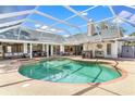 Aerial view of a large screened-in pool and patio area, ideal for outdoor enjoyment at 39206 Treeline Dr, Lady Lake, FL 32159