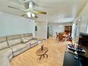 Open-concept living area with living room and dining area featuring wood-look flooring at 40226 Palm St, Lady Lake, FL 32159