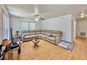 Spacious living room featuring a sectional sofa, ceiling fan, and wood-look flooring at 40226 Palm St, Lady Lake, FL 32159