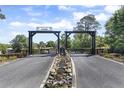 Grand gated entrance with a water feature, leading to a private and serene estate at 41522 Saddle Ridge Ln, Weirsdale, FL 32195