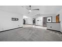 Expansive living room featuring carpet floors, modern lighting, and neutral walls at 5011 Se 33Rd Ave, Ocala, FL 34480