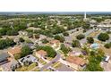 Aerial view of the house showcasing its location within the neighborhood, surrounded by lush greenery at 520 Rob Roy Dr, Clermont, FL 34711