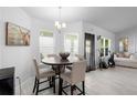 Bright dining area with stylish table, wood floors, and seamless access to kitchen at 5890 Sw 83Rd St, Ocala, FL 34476
