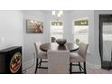 Cozy dining area with modern light fixture and charming accent art at 5890 Sw 83Rd St, Ocala, FL 34476
