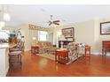 Comfortable living room with hardwood floors, ceiling fan and natural light at 6104 Hunters Ridge Ave, Leesburg, FL 34748