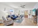 Bright living room featuring comfortable seating, stylish decor, and tile floors at 732 Ramirez Ave, The Villages, FL 32159