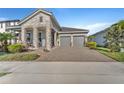 Charming home with a two-car garage, brick-paved driveway, and well-maintained landscaping at 8272 Procida Isle Ln, Windermere, FL 34786