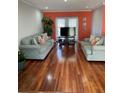 Spacious living room with hardwood floors and comfortable sofas for relaxing and entertaining at 879 Little Bend Rd, Altamonte Springs, FL 32714