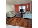 Comfortable living room featuring hardwood floors, modern furnishings, and lots of natural light at 879 Little Bend Rd, Altamonte Springs, FL 32714