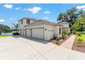 Gorgeous home featuring a three-car garage, driveway, and beautifully landscaped surroundings at 1111 Myrtle Breezes Ct, Fruitland Park, FL 34731