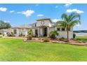 Beautiful home features a manicured lawn, well-maintained landscaping, and a modern architectural style near the lake at 1111 Myrtle Breezes Ct, Fruitland Park, FL 34731