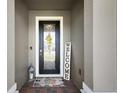 Inviting front door with decorative glass, a welcome mat, and a charming welcome sign at 456 Winter Solstice Ln, Mount Dora, FL 32757