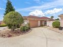 Charming single-story home showcasing meticulous landscaping and a spacious driveway at 632 Delgado Ave, The Villages, FL 32159