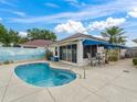 Inviting kidney-shaped pool with a covered patio and a serene backyard setting at 632 Delgado Ave, The Villages, FL 32159