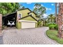 Two story home with a brick driveway, a two car garage, and extra parking at 9642 Bear Lake Rd, Apopka, FL 32703