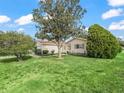 Beautiful single-Gathering home with mature trees accenting the front yard and walkway leading to the main entrance at 9757 Se 175Th Pl, Summerfield, FL 34491