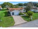 Charming single-Gathering home featuring a well-manicured lawn, mature landscaping, and an attached two-car garage at 9757 Se 175Th Pl, Summerfield, FL 34491