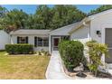 Charming front entrance with lush landscaping and a well-manicured lawn at 1212 Chaparral Dr, Lady Lake, FL 32159