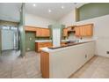 Bright kitchen with tile flooring and wooden cabinetry at 1307 Rain Forest Ln, Minneola, FL 34715