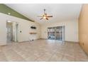 Open living room with tile floors and a sliding glass door at 1307 Rain Forest Ln, Minneola, FL 34715