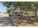 Attractive single-story home featuring a neatly landscaped yard and a long driveway at 13301 Biscayne Dr, Grand Island, FL 32735