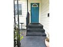 Inviting entrance featuring a vibrant blue front door with steps leading up to the home at 1414 Margate Ave, Orlando, FL 32803