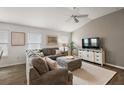 Comfortable living room featuring a large sectional sofa and modern entertainment center, filled with natural light at 1486 Joshua Ct, The Villages, FL 32163