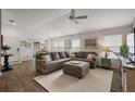 Spacious living room featuring a large sectional sofa, wood floors, and ample natural light at 1486 Joshua Ct, The Villages, FL 32163