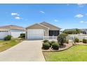Charming home featuring a well-manicured front yard, a white picket fence, and a one-car garage at 1486 Olympia St, The Villages, FL 32163