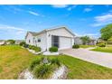 A well-maintained house with a brick driveway and manicured garden at 17587 Se 95Th Cir, Summerfield, FL 34491