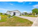 Charming single-story home featuring a brick driveway, well-maintained lawn, and two-car garage at 17587 Se 95Th Cir, Summerfield, FL 34491