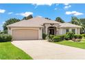 Charming single-story home with manicured landscaping and an attached two car garage at 1875 Saybrook Way, The Villages, FL 32162