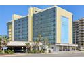 Exterior of Oceanside Inn highlighting the multiple levels of units and convenient porte-cochere entrance at 1909 S Atlantic Ave # 311312, Daytona Beach, FL 32118