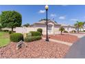 Lovely single-story home boasting neat landscaping, a lamp post, and a well-maintained lawn with decorative rocks at 2128 Alfredo Ave, Lady Lake, FL 32159