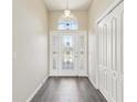 Bright foyer with decorative front door, tiled floor, closet, and neutral walls creates an inviting entryway at 2139 Kaylee Dr, The Villages, FL 32162