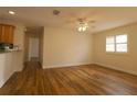 Bright, open living room featuring hardwood floors, plantation shutters, and a ceiling fan at 2449 Kingstree Pl, The Villages, FL 32162