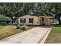 Charming single-story home with a well-manicured front yard, and a covered parking area at 24802 Pine Hl, Leesburg, FL 34748