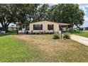 Charming single-story home features a screened-in porch and a well-maintained front yard with mature landscaping at 24802 Pine Hl, Leesburg, FL 34748