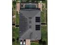 Aerial view of the house, showcasing the roof with solar panels and a backyard pool at 2504 Cavender Creek Rd, Minneola, FL 34715